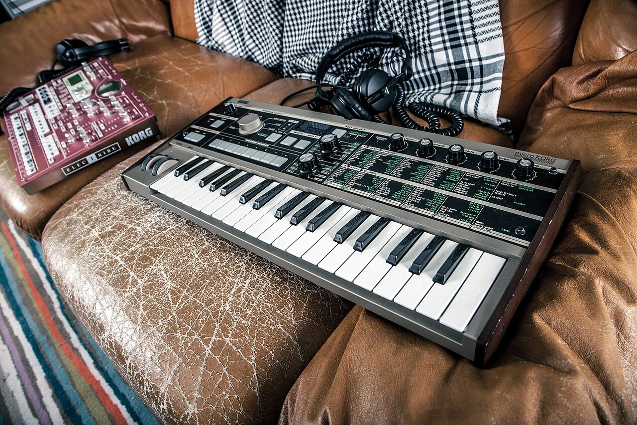 Headphones beside equipment used to listen to and make music.